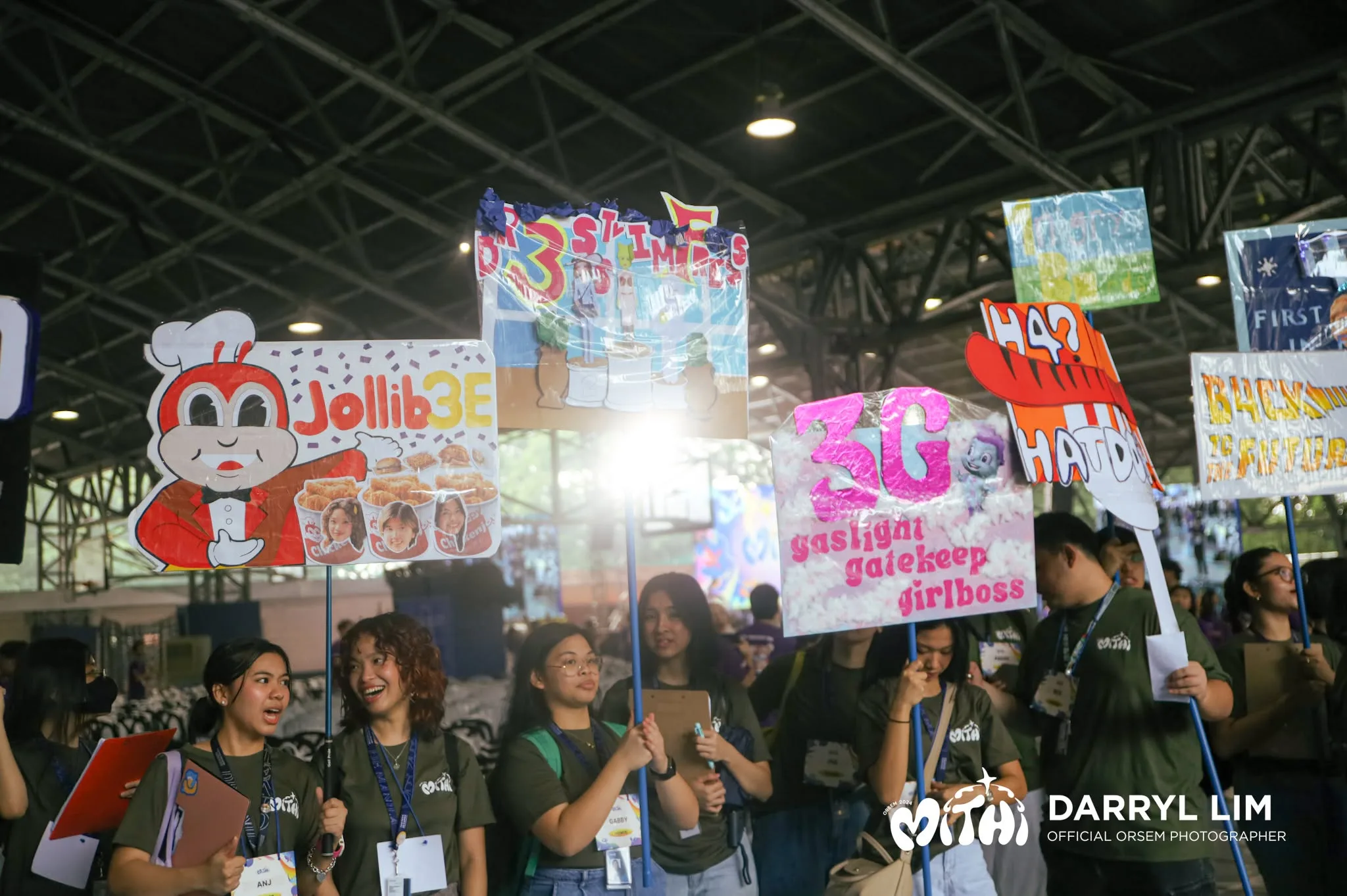 OrSem volunteers holding handmade concessionaire signs