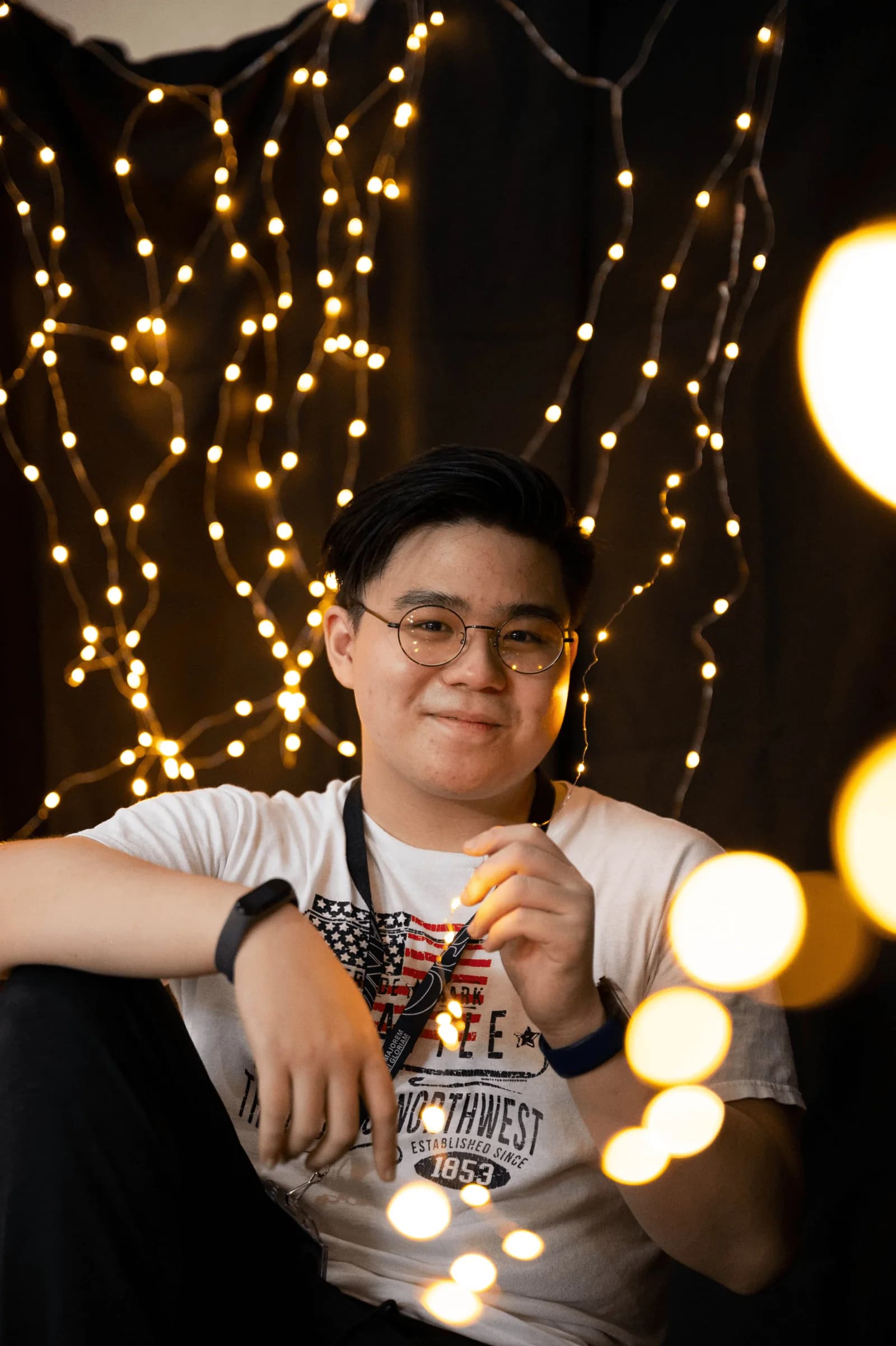 Andre Dalwin surrounded by warm string lights