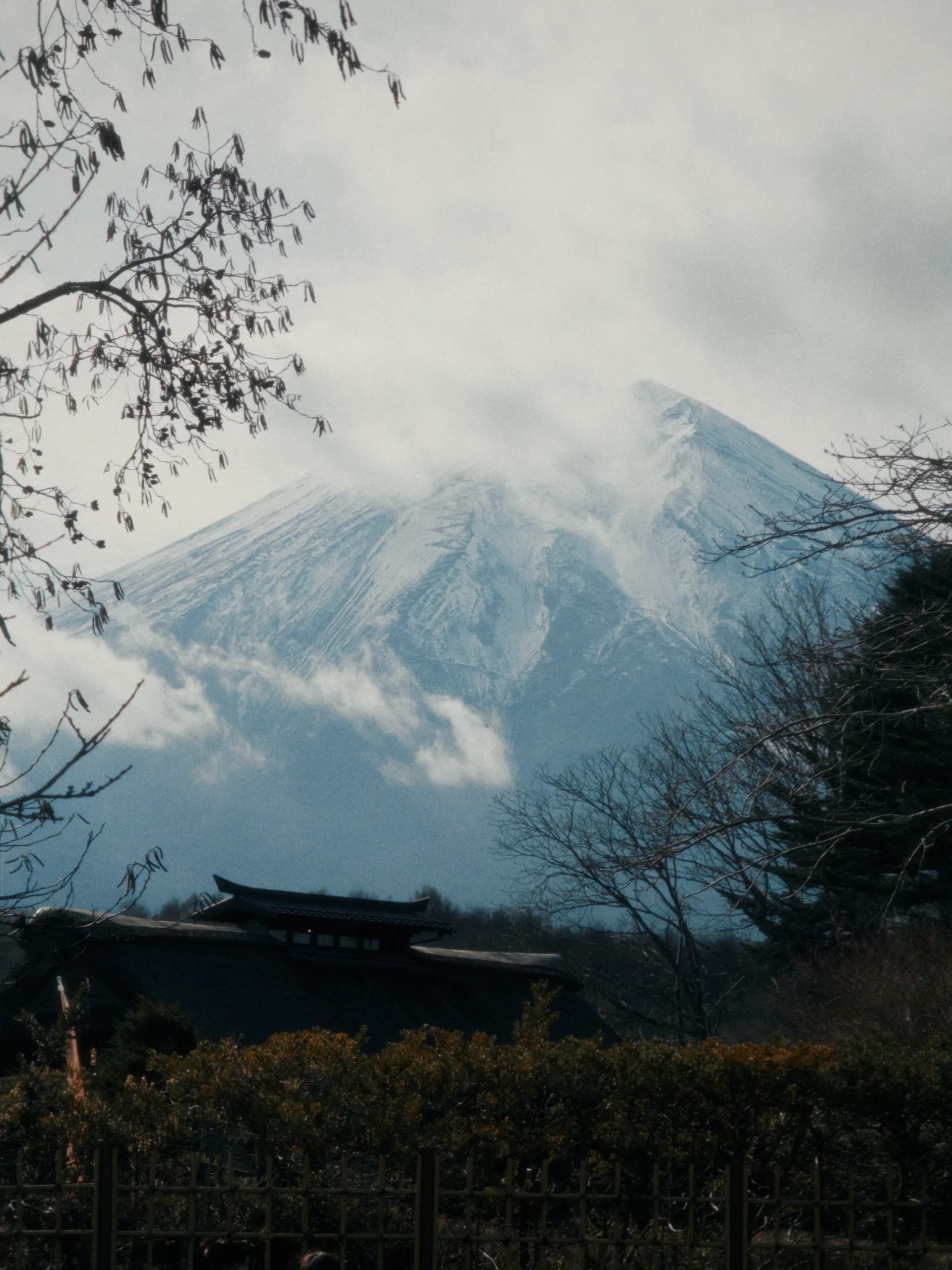 Mount Fuji partly hidden by cloud and winter light